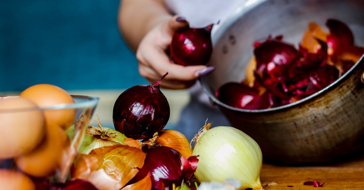 Red "white" onion? - Crop anonymous female peeling red and white onions into pan to naturally color Easter eggs for holiday Red "white" onion? - Crop anonymous female peeling red and white onions into pan to naturally color Easter eggs for holiday