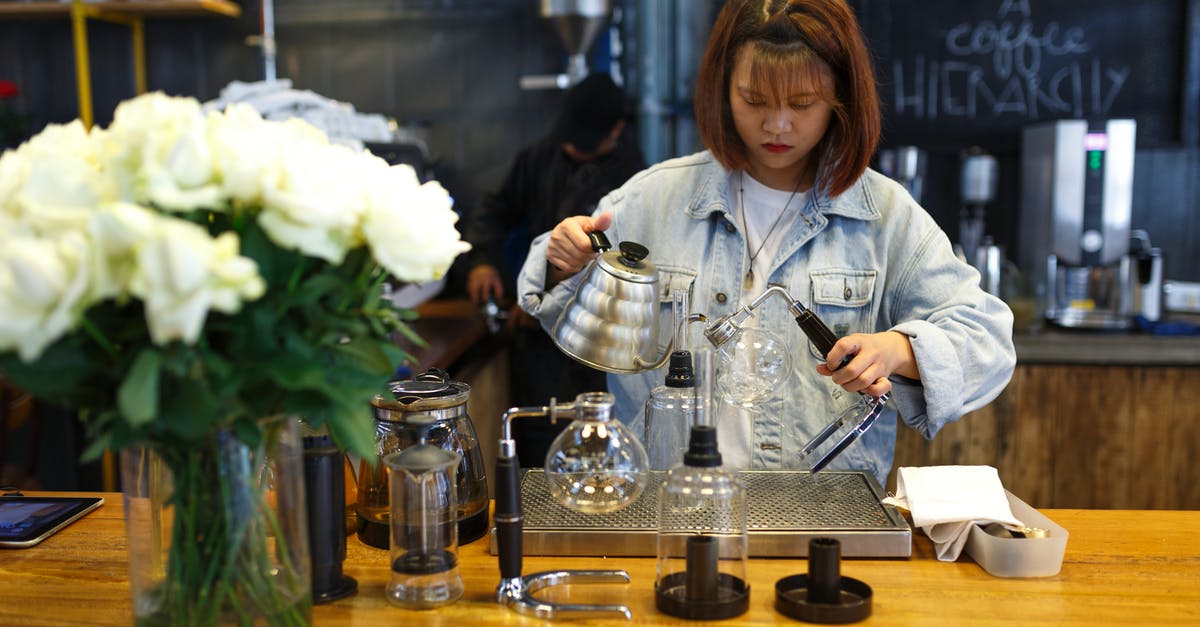 Reducing stock and then adding water - Woman Mixing Beverages Reducing stock and then adding water - Woman Mixing Beverages