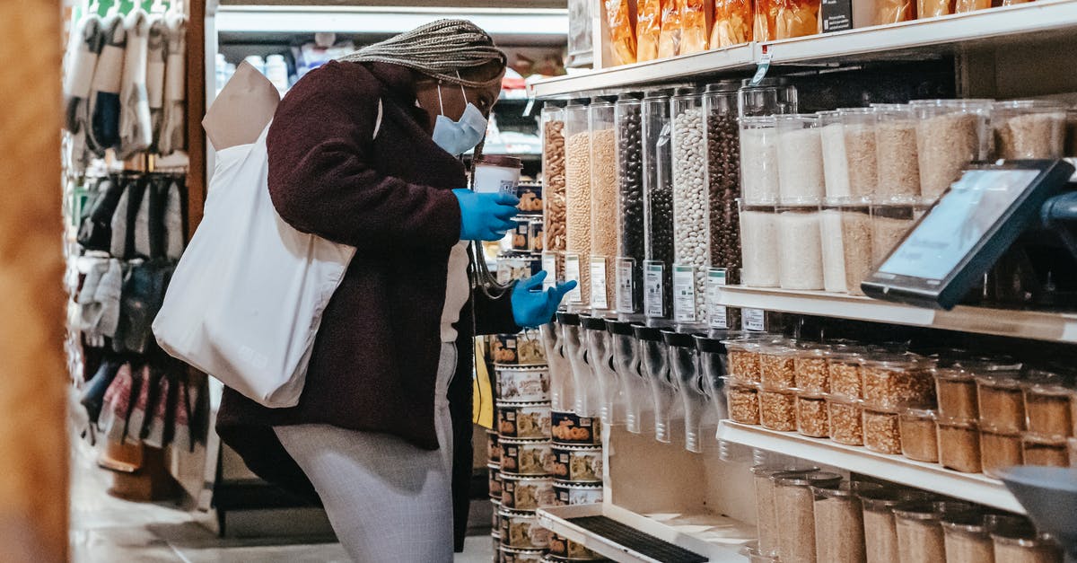 References on food safety? - Black woman choosing grains in supermarket References on food safety? - Black woman choosing grains in supermarket