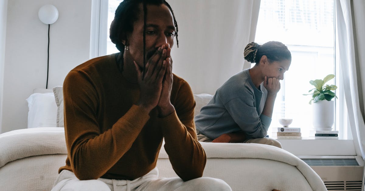 Refrigerate and separate patties - Wistful concerned African American couple in casual clothing sitting on bed at home after having quarrel Refrigerate and separate patties - Wistful concerned African American couple in casual clothing sitting on bed at home after having quarrel