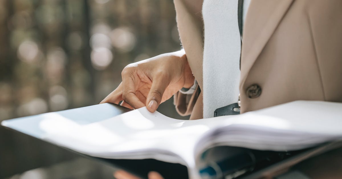 Refrigerated lunchboxes turn soggy - Crop faceless female entrepreneur in stylish jacket reading important documents in black folder Refrigerated lunchboxes turn soggy - Crop faceless female entrepreneur in stylish jacket reading important documents in black folder
