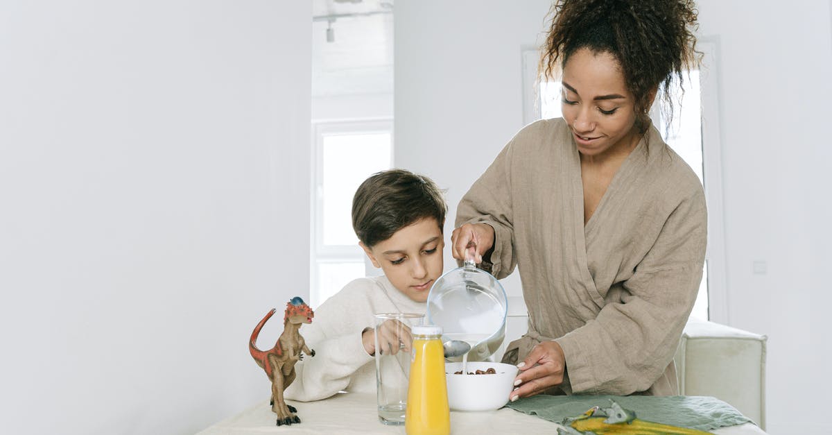 Refrigerating Clam Juice - Woman in Gray Long Sleeve Shirt Sitting Beside Woman in Gray Long Sleeve Shirt Refrigerating Clam Juice - Woman in Gray Long Sleeve Shirt Sitting Beside Woman in Gray Long Sleeve Shirt