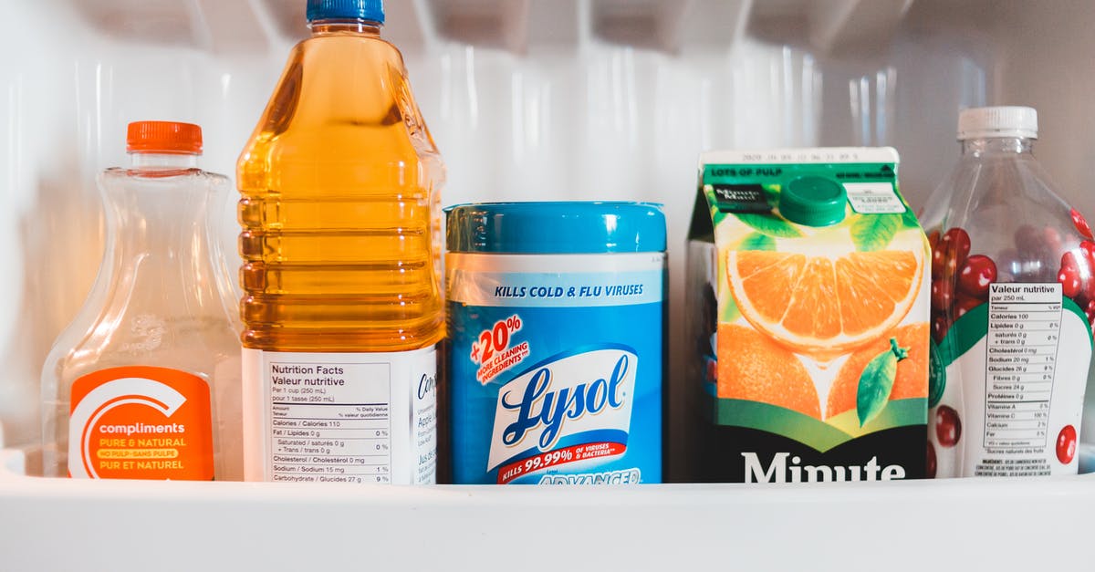 Refrigerating Clam Juice - Bottles with assorted juices in refrigerator Refrigerating Clam Juice - Bottles with assorted juices in refrigerator