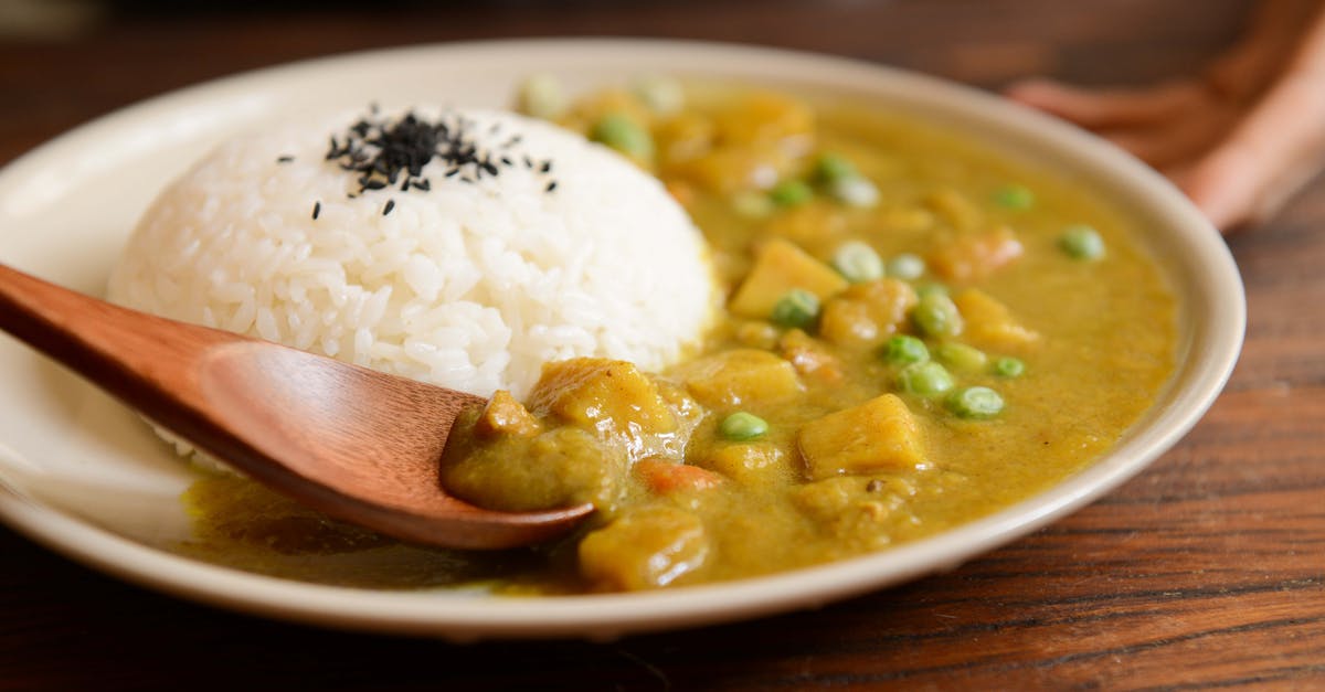 Reheating and Storing Chicken/Potato Soup For 10 Hours - Cooked Rice and Curry Food Served on White Plate Reheating and Storing Chicken/Potato Soup For 10 Hours - Cooked Rice and Curry Food Served on White Plate