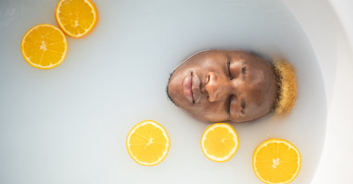 re-hydrate dried and salted cod with water and milk - Black man immersed in bathtub re-hydrate dried and salted cod with water and milk - Black man immersed in bathtub