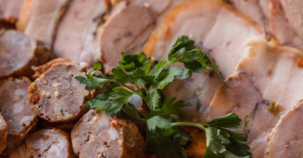 Removing fat from a recipe - From above of tasty sliced sausage and meat placed on plate in daytime Removing fat from a recipe - From above of tasty sliced sausage and meat placed on plate in daytime