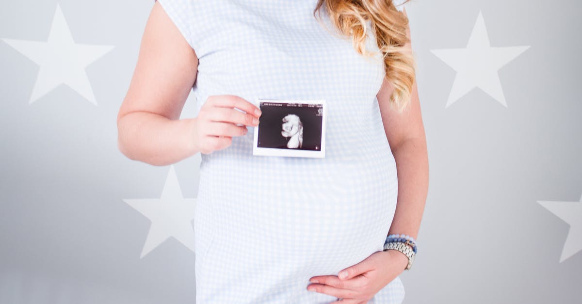 Removing hair from pork belly - Woman Wearing White Cap-sleeved Dress Holding Ultrasound Result Photo Removing hair from pork belly - Woman Wearing White Cap-sleeved Dress Holding Ultrasound Result Photo
