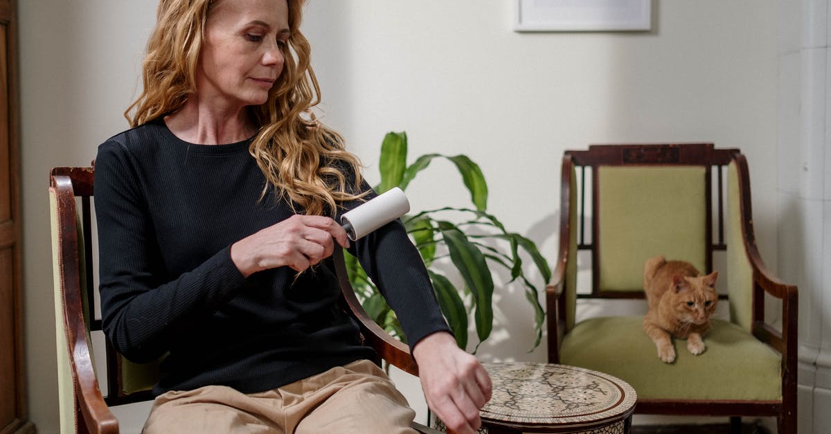 Removing long-term residue from teflon - Woman Using Lint Remover Removing long-term residue from teflon - Woman Using Lint Remover