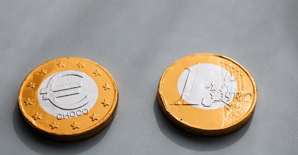 Removing metal disc ring from chocolate mousse: which method should I use? - Coins one euros lying on gray table Removing metal disc ring from chocolate mousse: which method should I use? - Coins one euros lying on gray table