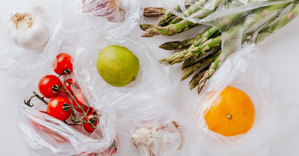 Removing turmeric stains from white plastic [duplicate] - From above of bunch of tomatoes with raw asparagus put into transparent plastic bags on white table near citrus fruits and garlic bulbs
