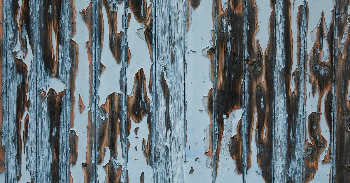 Removing white Corrosion on my rice cooker heating element [closed] - Timber wall of aged house with peeling white paint and damaged textured planks