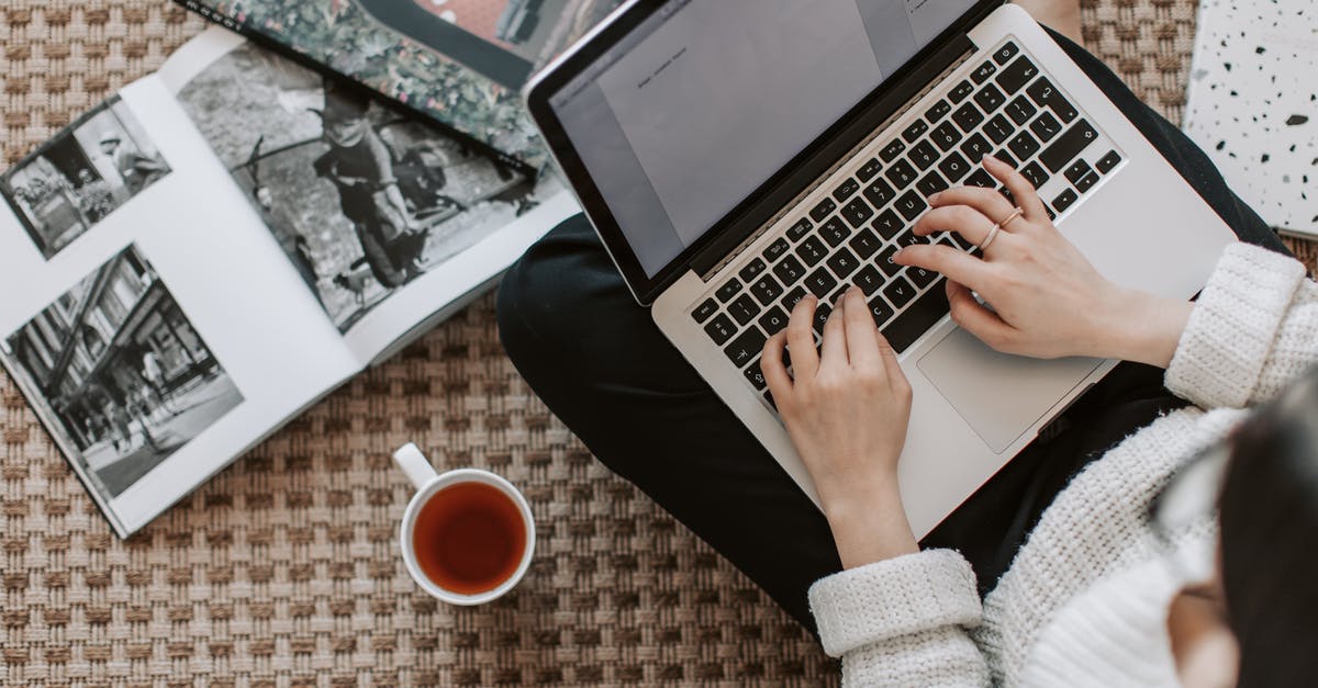 Residue in a cup of tea using household filter - Crop young businesswoman using laptop while drinking tea at home Residue in a cup of tea using household filter - Crop young businesswoman using laptop while drinking tea at home