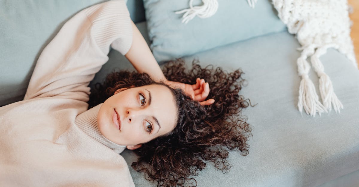 Resting for brownie batter - Woman in Turtle Neck Sweater Lying Near the Throw Pillows while Looking Afar Resting for brownie batter - Woman in Turtle Neck Sweater Lying Near the Throw Pillows while Looking Afar