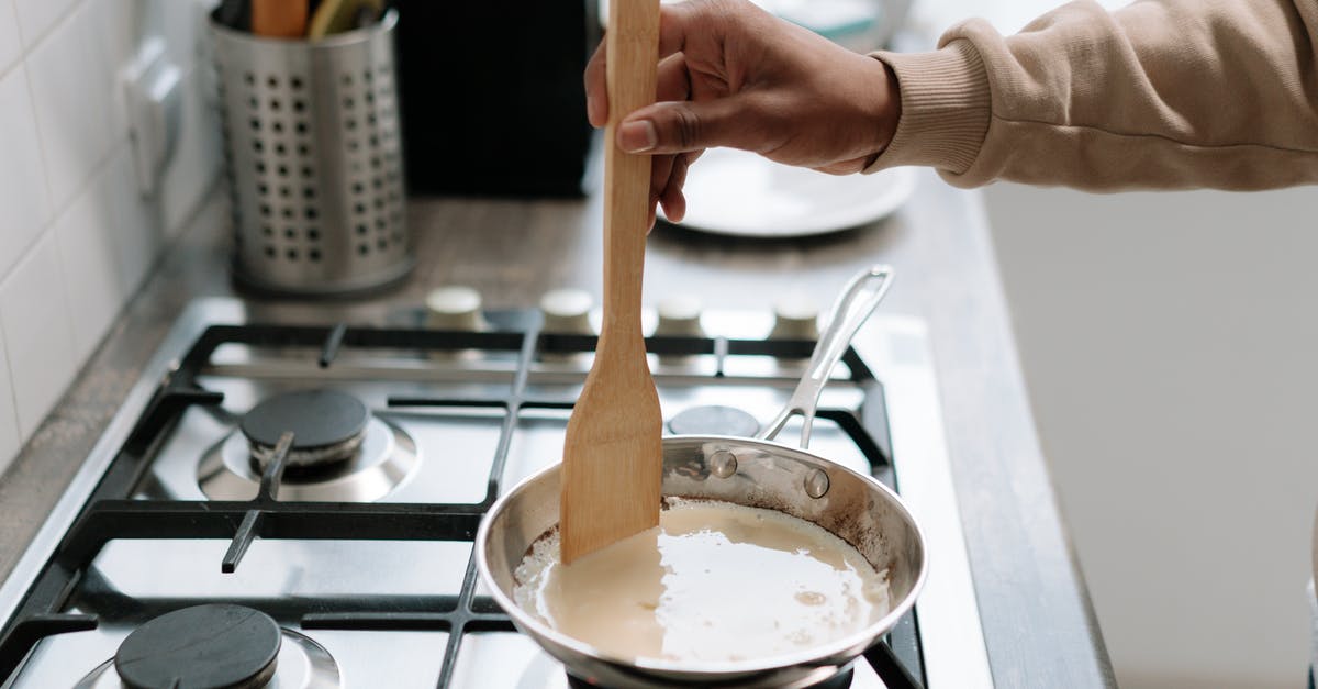 Reuse frying & sauce pans multiple times during cooking session - Person Holding Brown Wooden Ladle on a Pan Reuse frying & sauce pans multiple times during cooking session - Person Holding Brown Wooden Ladle on a Pan