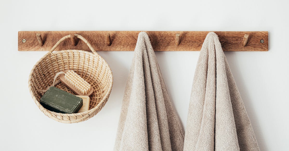 Reusing pickle brine - Wooden hanger with towels and basket with bathroom products Reusing pickle brine - Wooden hanger with towels and basket with bathroom products