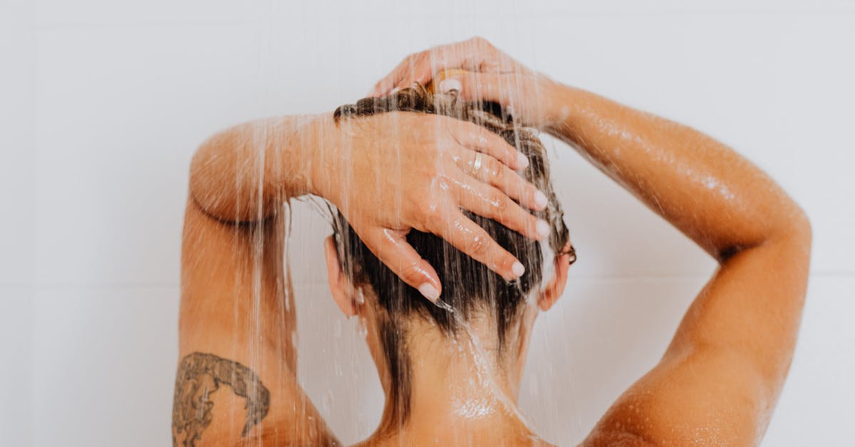 Rice: Measuring water after washing it - Woman With Black Floral Tattoo on Her Body Rice: Measuring water after washing it - Woman With Black Floral Tattoo on Her Body