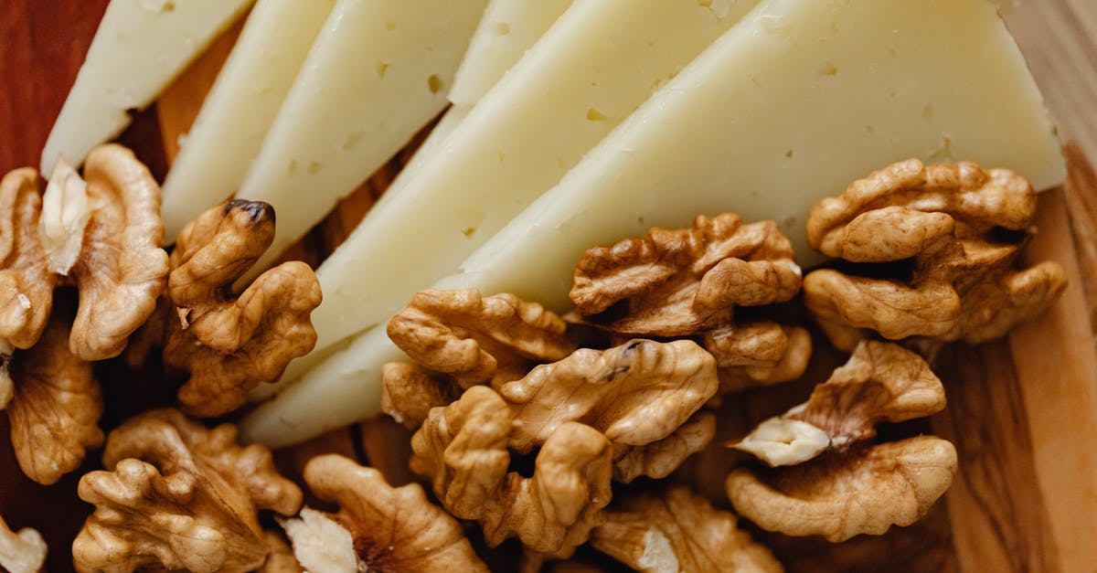 Roasting nuts with versus without oil. Is there any significant difference? - Sliced Cheese and Roasted Walnuts on Wooden Board