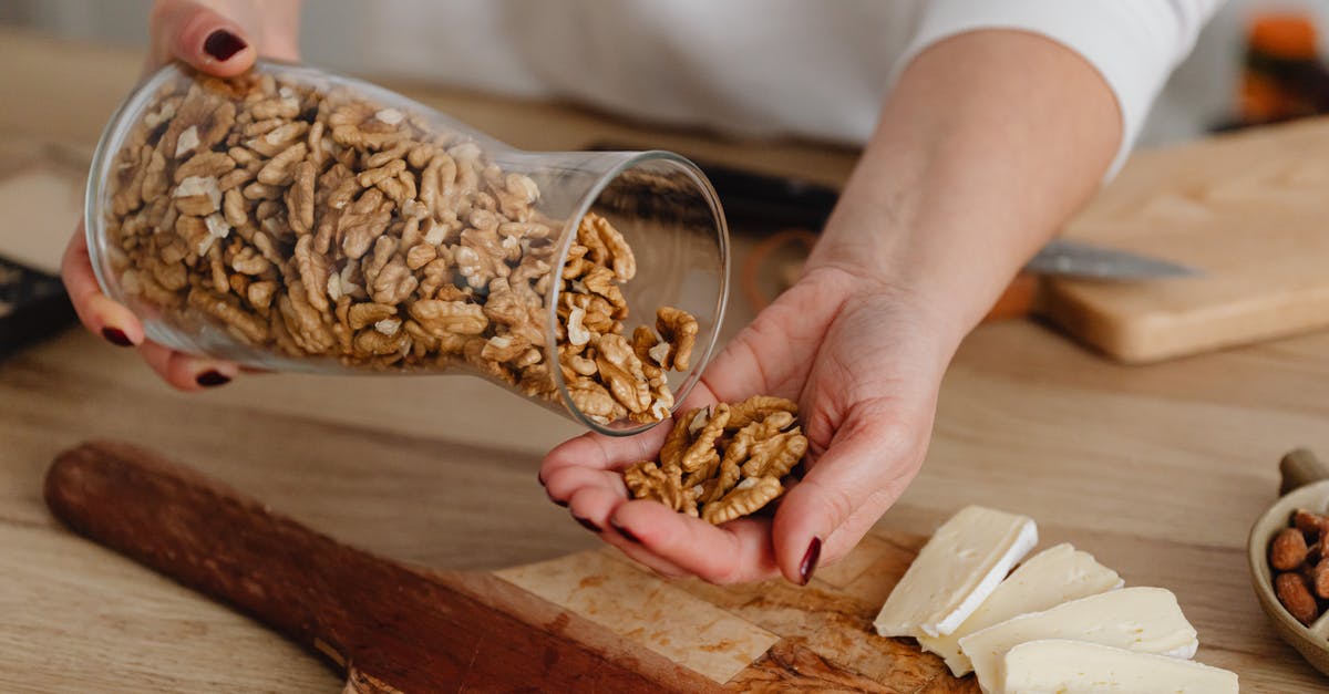 Roasting nuts with versus without oil. Is there any significant difference? - Person Holding Brown Wooden Chopping Board With Brown Dried Leaves