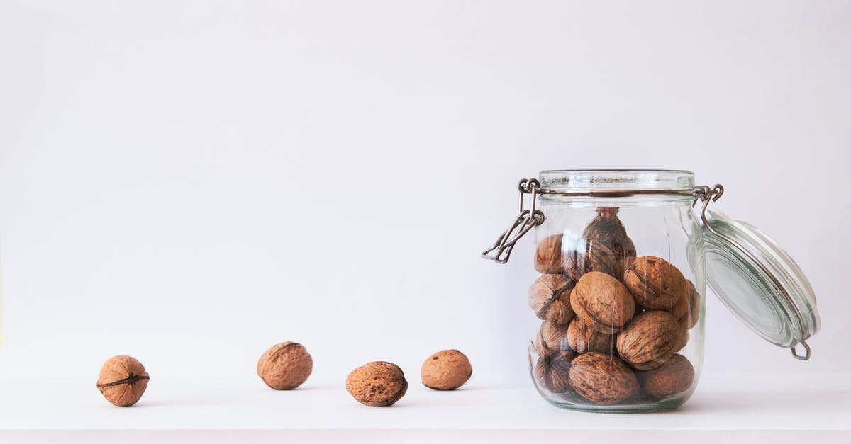 Roughly chopping large batches of hard nuts - Walnut in Clear Glass Jar Roughly chopping large batches of hard nuts - Walnut in Clear Glass Jar