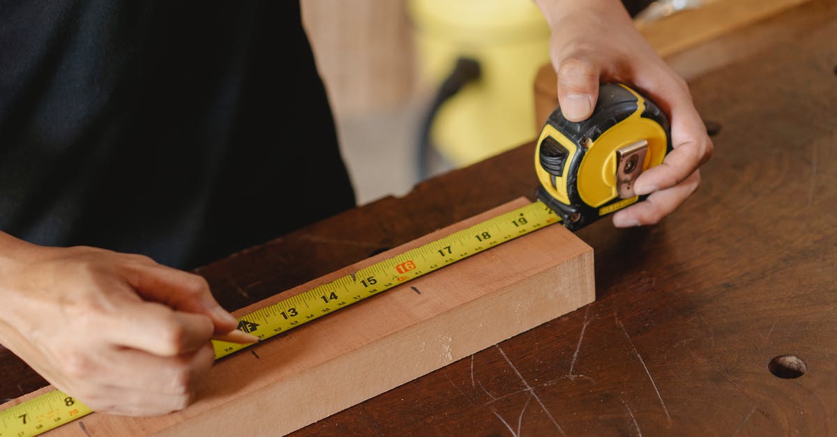 Royal icing - how important is accurate measuring? - Crop man using ruler in workshop Royal icing - how important is accurate measuring? - Crop man using ruler in workshop