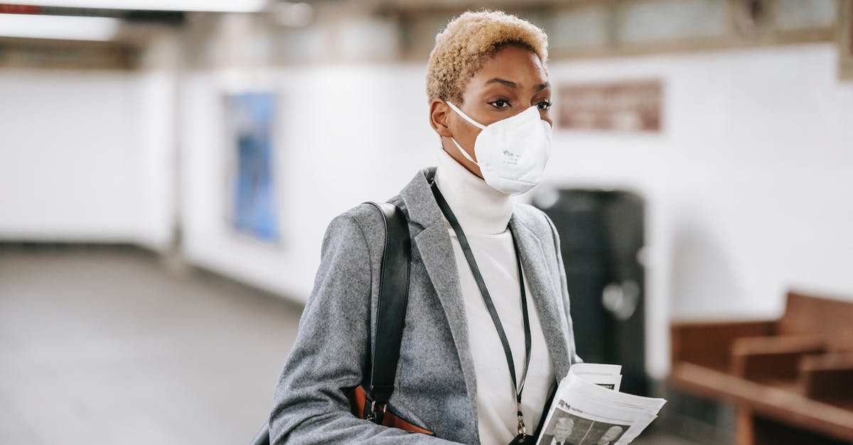 Royal icing safety concern - Pensive black woman with newspaper standing in public hallway Royal icing safety concern - Pensive black woman with newspaper standing in public hallway