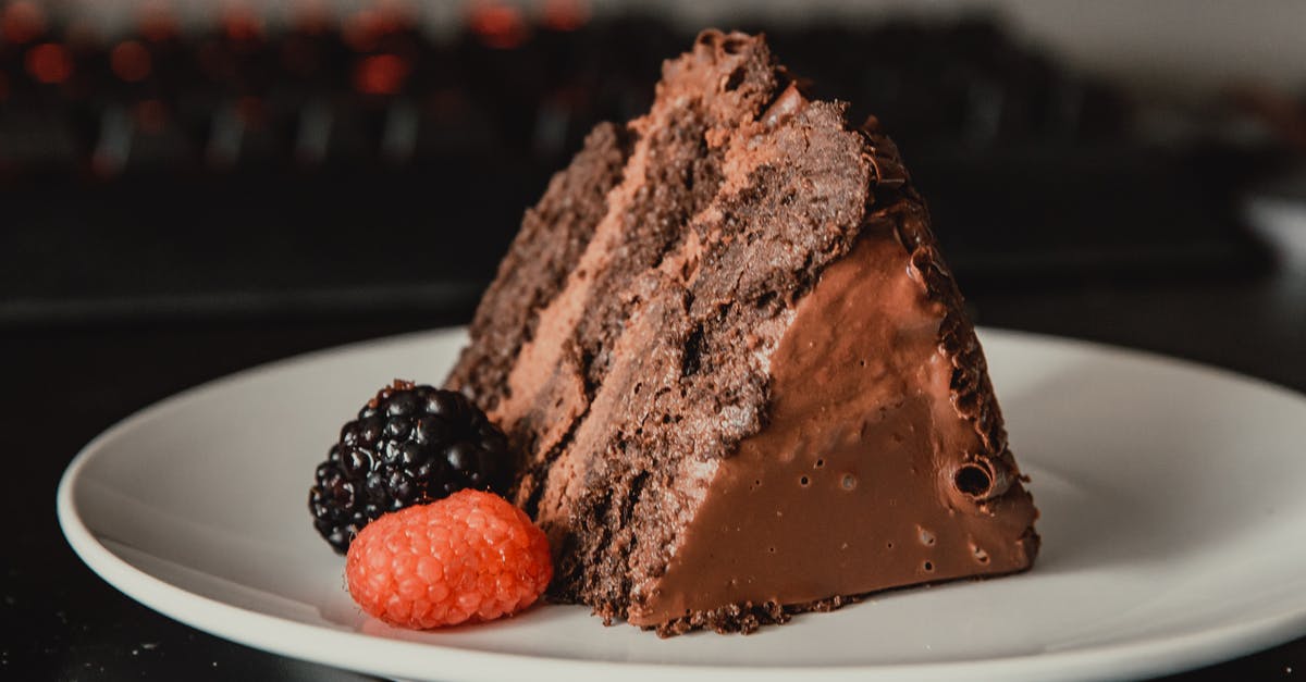 Russian Pie Recipe breaks into little pieces? - Appetizing sweet dark chocolate cake served on white plate and decorated with ripe black and red blackberries Russian Pie Recipe breaks into little pieces? - Appetizing sweet dark chocolate cake served on white plate and decorated with ripe black and red blackberries