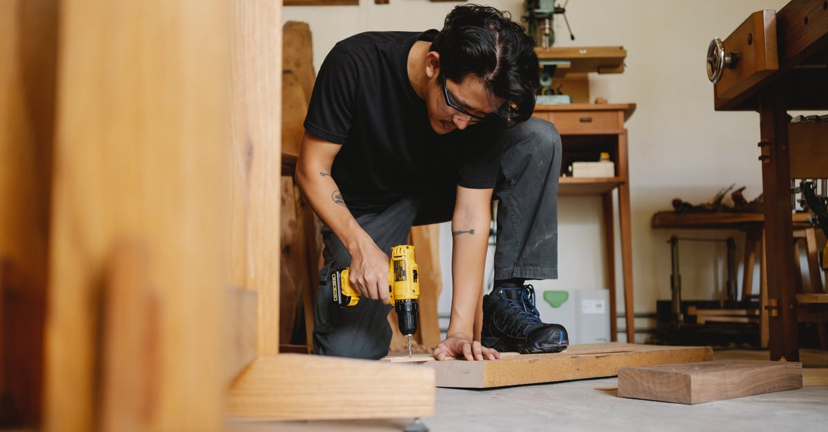 Safety glasses in the kitchen: why are these not common place? - Pensive male drilling wooden surface of plank in workshop with equipment for carpentry Safety glasses in the kitchen: why are these not common place? - Pensive male drilling wooden surface of plank in workshop with equipment for carpentry
