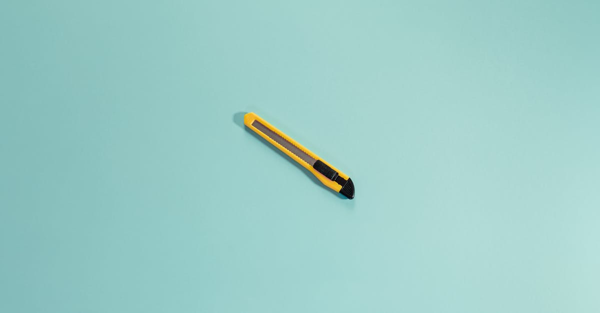 Safety Question about making stainless steel flat-top - From above of yellow stationery knife with sharp blades placed in center of bright empty background in daylight in modern studio Safety Question about making stainless steel flat-top - From above of yellow stationery knife with sharp blades placed in center of bright empty background in daylight in modern studio