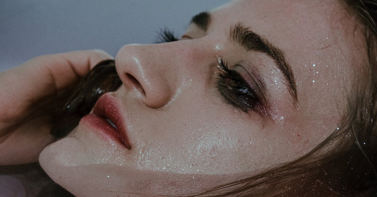 Salty water in the pressure cooker? - Young female with wet face touching hair in clean transparent water of bathtub Salty water in the pressure cooker? - Young female with wet face touching hair in clean transparent water of bathtub
