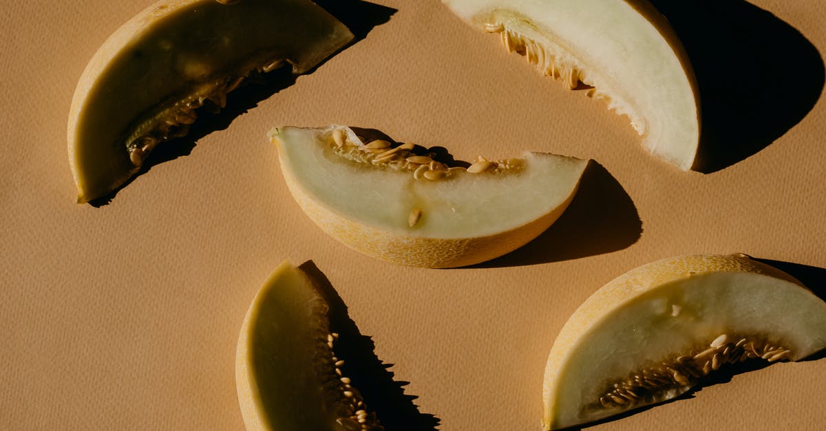 Santa Claus melon seeds - Fruit Slices on a Brown Surface Santa Claus melon seeds - Fruit Slices on a Brown Surface