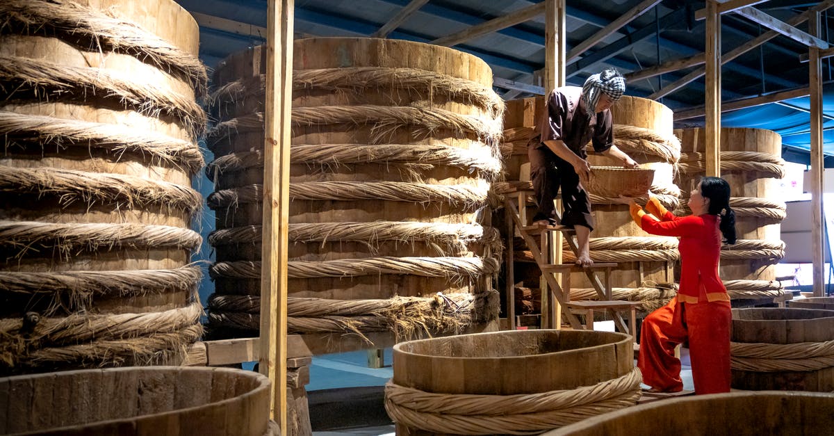 Sauce thickener for large batch - Colleagues working in warehouse with barrels Sauce thickener for large batch - Colleagues working in warehouse with barrels