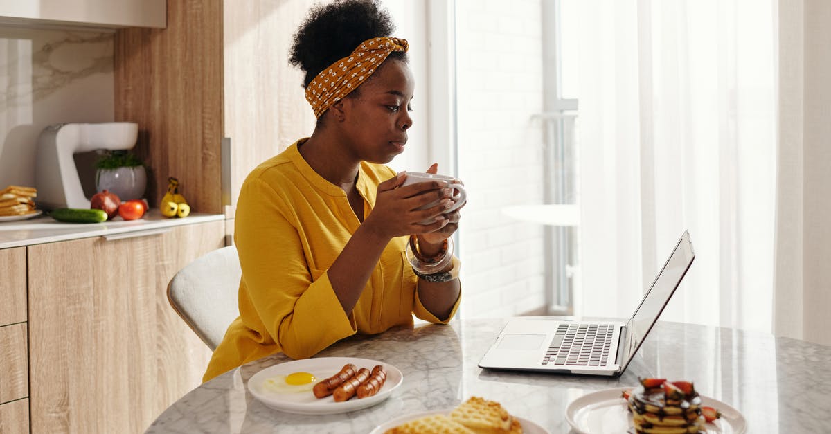 Sausage exploded and looks foamy - A Woman Holding a Cup While Looking at a Laptop Sausage exploded and looks foamy - A Woman Holding a Cup While Looking at a Laptop
