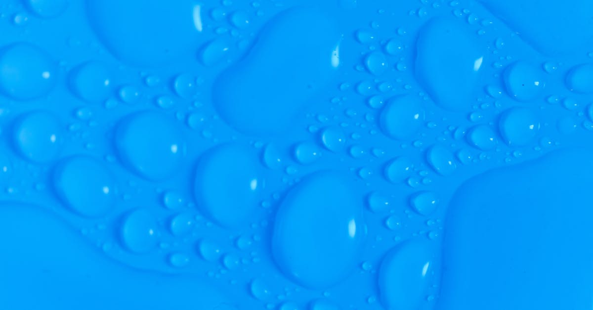 Sausage roll pastry - how do I achieve a smooth shiny effect? - Closeup top view of dark blue wet blurred background with still shiny abstract transparent fluid drops of different sizes and shapes Sausage roll pastry - how do I achieve a smooth shiny effect? - Closeup top view of dark blue wet blurred background with still shiny abstract transparent fluid drops of different sizes and shapes