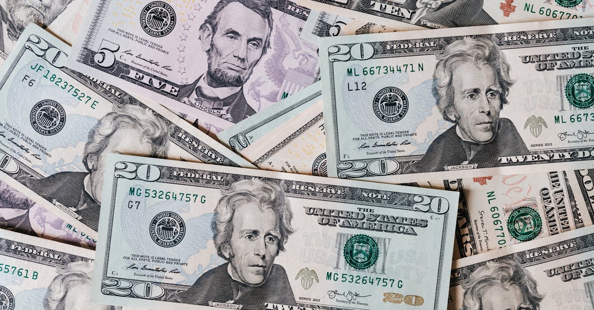 Saving spoiling mushrooms? - Top view of different types and colors American dollars placed together on each other Saving spoiling mushrooms? - Top view of different types and colors American dollars placed together on each other