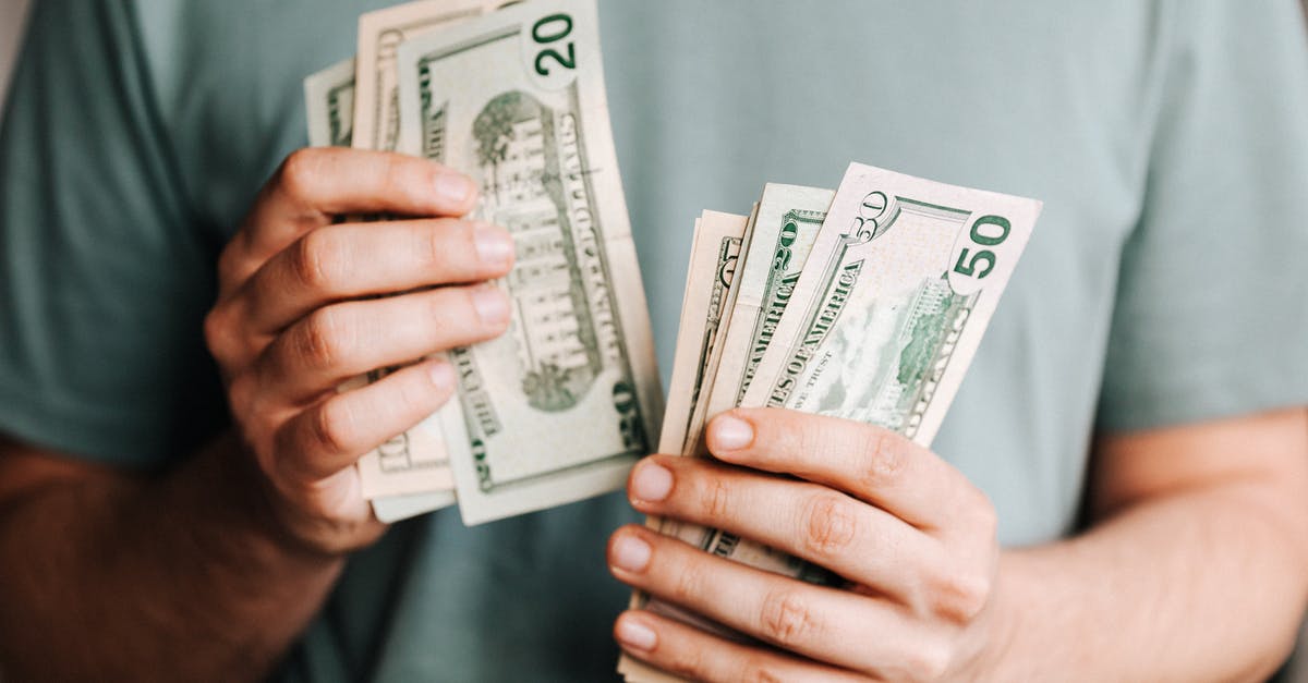 Saving spoiling mushrooms? - Crop man counting dollar banknotes Saving spoiling mushrooms? - Crop man counting dollar banknotes