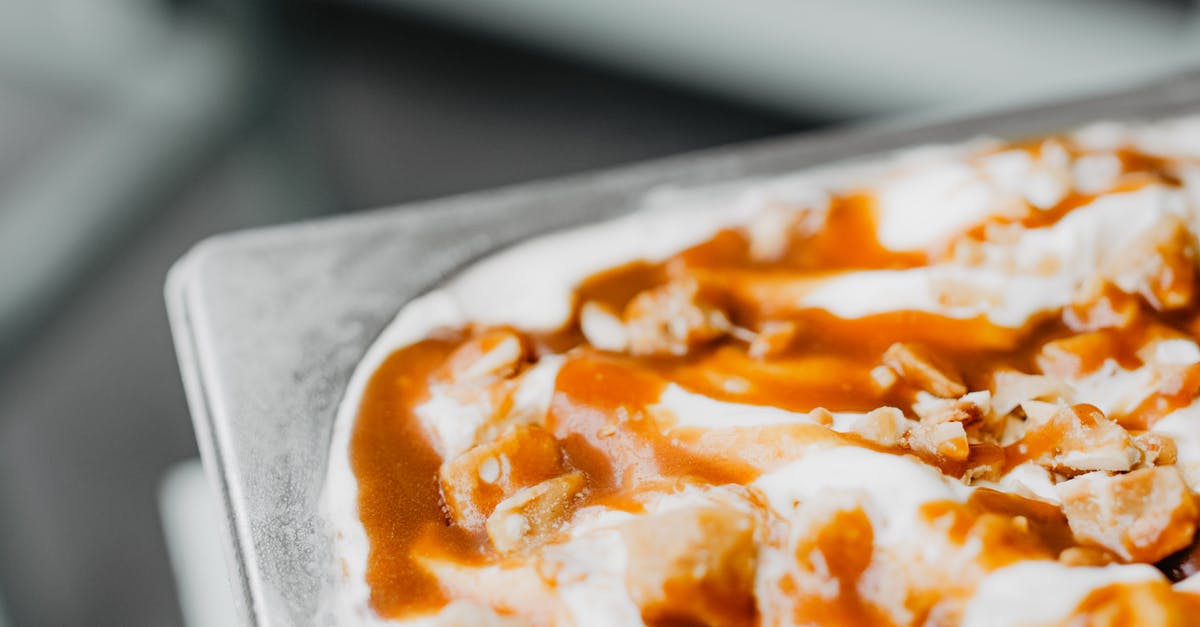 Scraping Caramel for Flan - Close-up of a Tray with Ice Cream with Caramel Sauce Scraping Caramel for Flan - Close-up of a Tray with Ice Cream with Caramel Sauce
