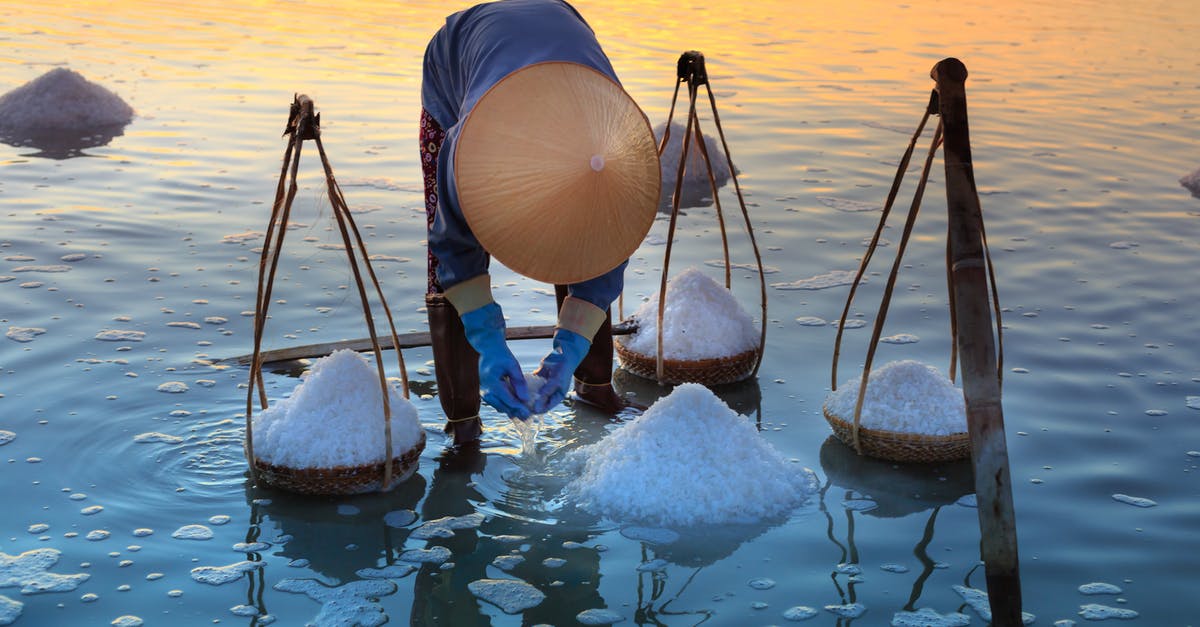 Sea Salt and Mercury - Person Collecting Salt on Body of Water Sea Salt and Mercury - Person Collecting Salt on Body of Water