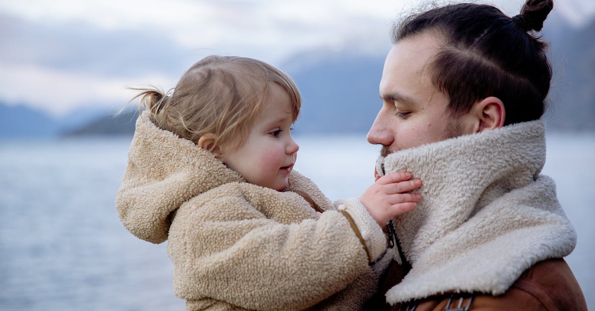 Seasoning Chili for Young Children - Satisfied young father and little daughter near sea in cold season Seasoning Chili for Young Children - Satisfied young father and little daughter near sea in cold season