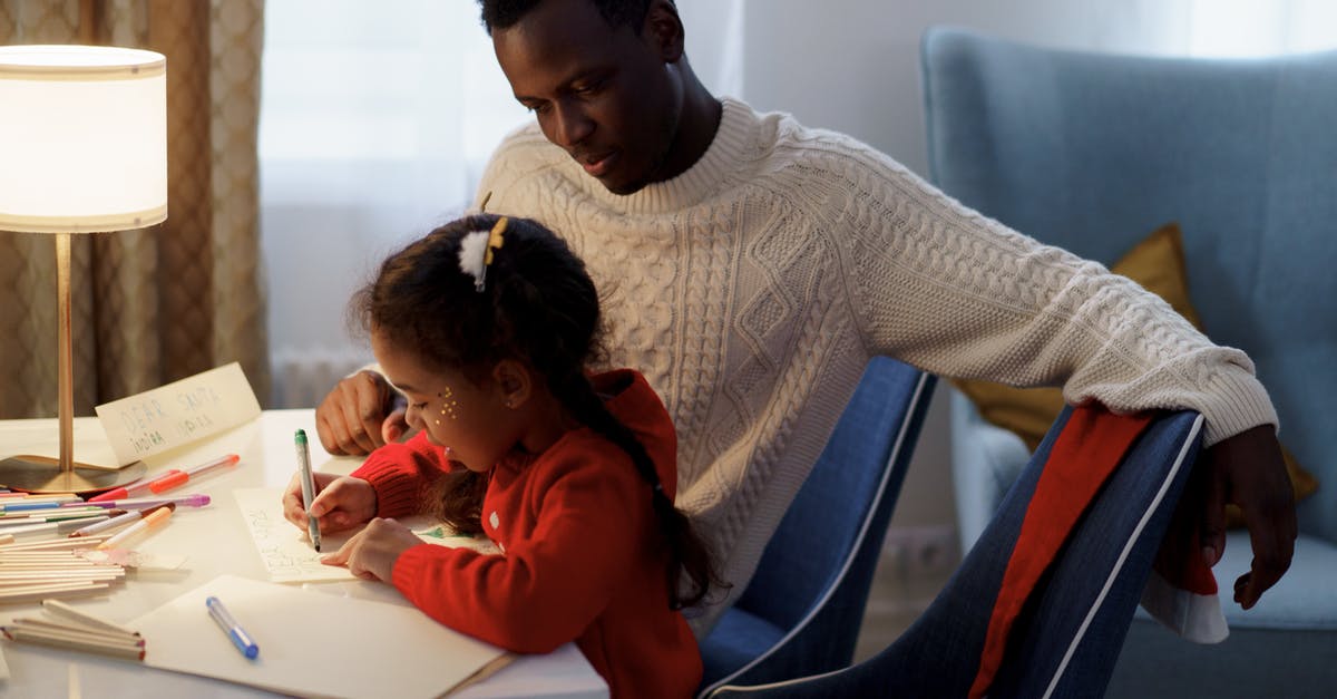 Seasoning Chili for Young Children - Dad Watching Her Daughter Make a Christmas Letter Seasoning Chili for Young Children - Dad Watching Her Daughter Make a Christmas Letter