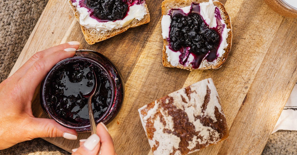 Seedless blueberry jam - consistency - Person Holding Brown Wooden Stick With Chocolate Cake Seedless blueberry jam - consistency - Person Holding Brown Wooden Stick With Chocolate Cake