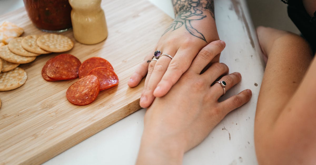 Separating chocolate-coated cookies stuck together - A Sweet Couple Touching Hands While Having Breakfast Separating chocolate-coated cookies stuck together - A Sweet Couple Touching Hands While Having Breakfast