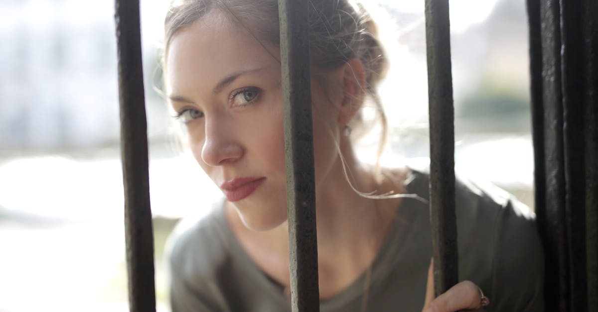 Serious buildup outside of cast iron skillet - Young beautiful female with bewitching look leaning on iron black bars and looking at camera while standing at fence on sunny day Serious buildup outside of cast iron skillet - Young beautiful female with bewitching look leaning on iron black bars and looking at camera while standing at fence on sunny day