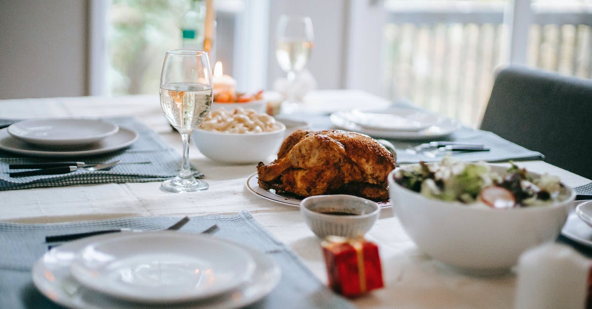 Serving a Whole Pig - Banquet table with delicious roasted turkey and vegetable salad near dishware during New Year holiday in house Serving a Whole Pig - Banquet table with delicious roasted turkey and vegetable salad near dishware during New Year holiday in house