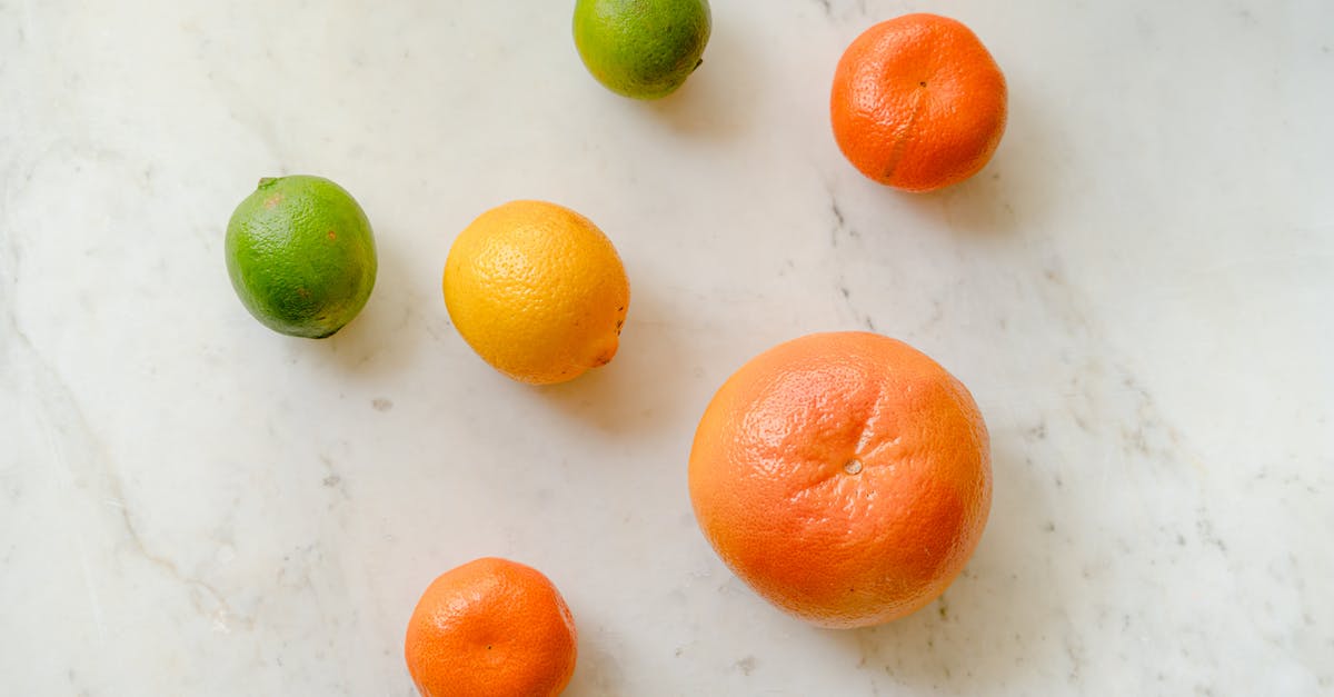 Serving a Whole Pig - Top view of fresh whole grapefruit lemon tangerines and limes placed on marble surface Serving a Whole Pig - Top view of fresh whole grapefruit lemon tangerines and limes placed on marble surface