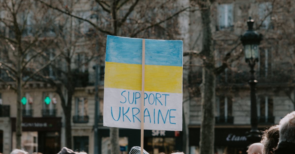 Serving Creme Brulee to a large group of people - Large Group of People Holding Banner on Supporting Ukraine Serving Creme Brulee to a large group of people - Large Group of People Holding Banner on Supporting Ukraine