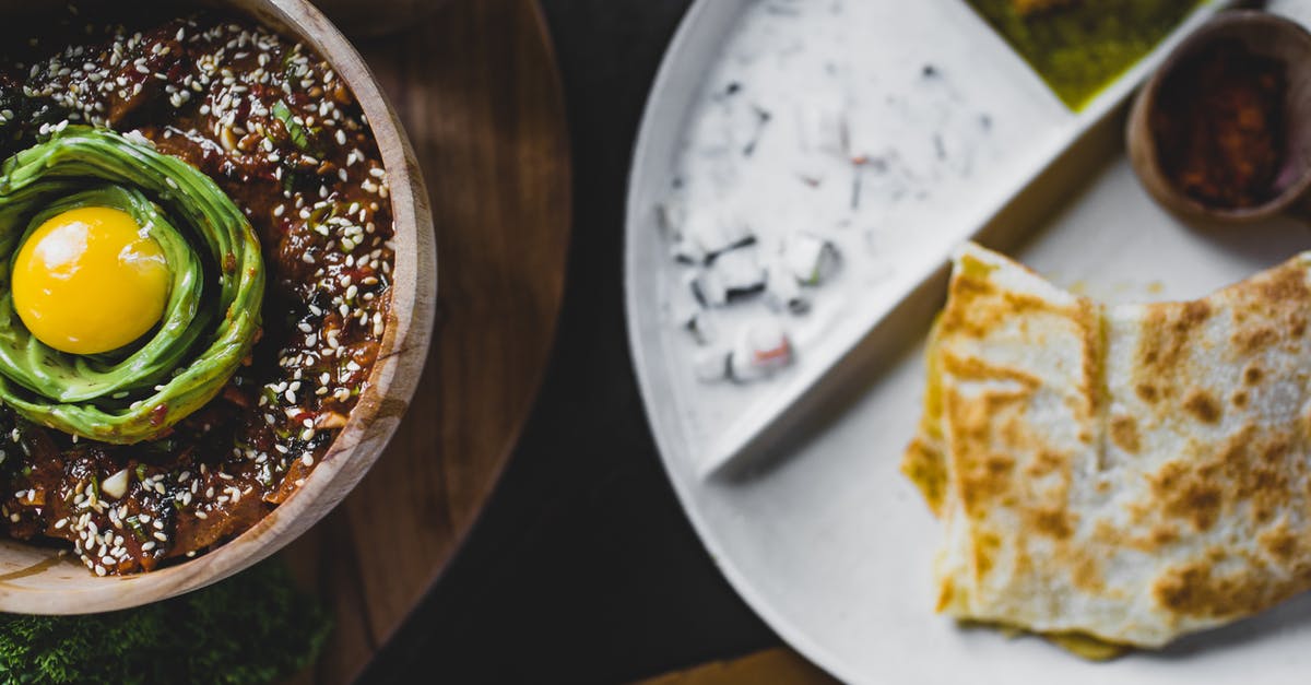 Sesame Seed replacement - From above of bowl with miso eggplant and avocado decorated with sesame seeds and placed near plate with delicious snacks Sesame Seed replacement - From above of bowl with miso eggplant and avocado decorated with sesame seeds and placed near plate with delicious snacks