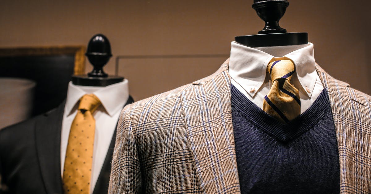 Sharpen a blue cheese dressing? - Dandy fancy jackets with shiny ties on dummies in showroom of contemporary male shop Sharpen a blue cheese dressing? - Dandy fancy jackets with shiny ties on dummies in showroom of contemporary male shop