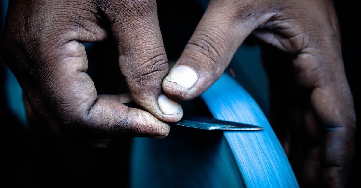 Sharpening a knife - Person Sharpening Knife Sharpening a knife - Person Sharpening Knife