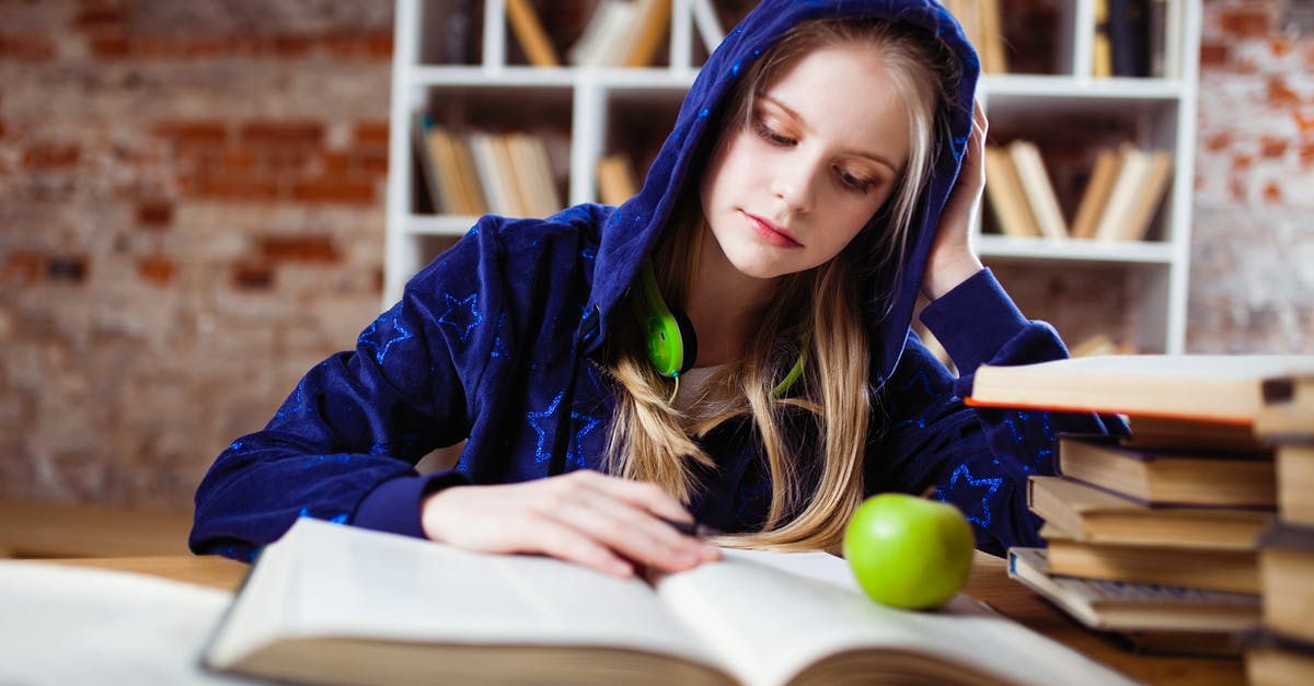 Shelf life of a caramel apple? - Woman Wearing Blue Jacket Sitting on Chair Near Table Reading Books