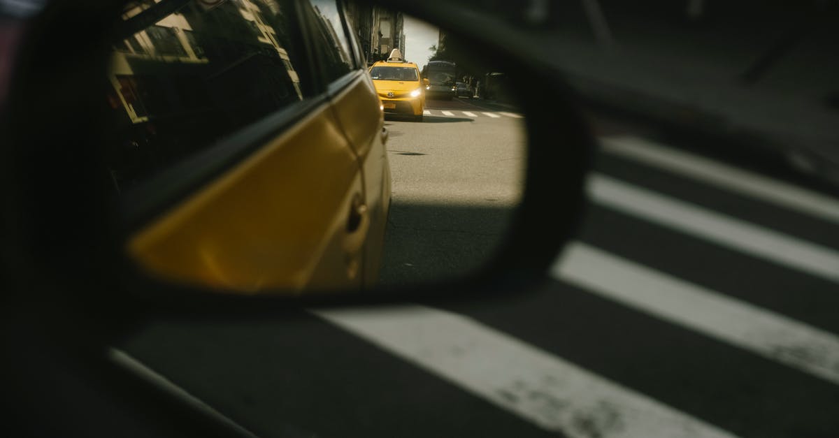 Shiny side or not for foil? - Modern taxi cars driving on road with crosswalk Shiny side or not for foil? - Modern taxi cars driving on road with crosswalk